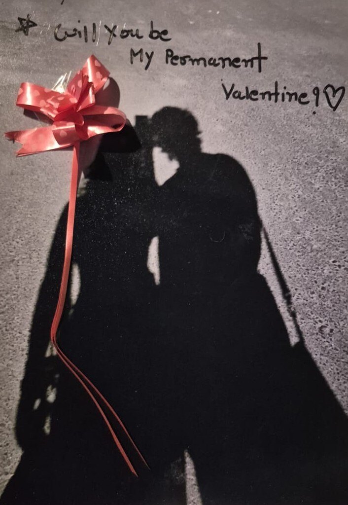 A handwritten permanent valentine message beside a shared shadow